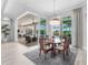 Well-lit dining room with an outdoor view and a stylish chandelier at 16407 Daysailor Trl, Lakewood Ranch, FL 34202