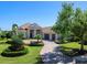 Beautiful one-story home boasting a tile roof, and a manicured front yard with lush landscaping at 16407 Daysailor Trl, Lakewood Ranch, FL 34202