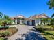 A picturesque one-story home with a spacious driveway and a beautifully landscaped front yard at 16407 Daysailor Trl, Lakewood Ranch, FL 34202