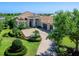 Beautiful home with a brick driveway, a two-car garage, and meticulous landscaping that invites you in at 16407 Daysailor Trl, Lakewood Ranch, FL 34202