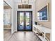 Bright foyer featuring herringbone floors, neutral walls, and a stylish console table at 16407 Daysailor Trl, Lakewood Ranch, FL 34202