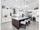 Modern kitchen featuring a large island, stainless appliances, and white cabinetry with ample storage at 16407 Daysailor Trl, Lakewood Ranch, FL 34202