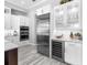 Close up on the modern kitchen featuring a stainless fridge, wine cooler and oven at 16407 Daysailor Trl, Lakewood Ranch, FL 34202