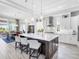Bright kitchen with island seating, stainless steel appliances, and a view to the dining and outdoor spaces at 16407 Daysailor Trl, Lakewood Ranch, FL 34202
