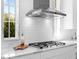Kitchen with subway tile backsplash, stainless vent hood, and gas range top at 16407 Daysailor Trl, Lakewood Ranch, FL 34202
