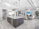 Open kitchen features a stainless fridge and appliances and large center island that opens to the living room at 16407 Daysailor Trl, Lakewood Ranch, FL 34202