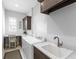 Bright laundry room features a washer, dryer, utility sink, and built in desk at 16407 Daysailor Trl, Lakewood Ranch, FL 34202