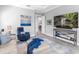 Relaxing living room with a wall mounted tv, artwork, and comfortable seating at 16407 Daysailor Trl, Lakewood Ranch, FL 34202