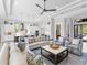Spacious living room featuring tray ceilings, comfortable seating, and an open-concept layout to the kitchen at 16407 Daysailor Trl, Lakewood Ranch, FL 34202
