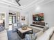Comfortable living room featuring a modern fireplace, stylish decor, and ample seating at 16407 Daysailor Trl, Lakewood Ranch, FL 34202