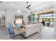 Bright living room with sliding glass doors to a covered patio, pool, and outdoor seating area at 16407 Daysailor Trl, Lakewood Ranch, FL 34202