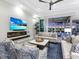 Comfortable living room with a fireplace, TV, and seamless flow to the outdoor pool area, perfect for entertaining at 16407 Daysailor Trl, Lakewood Ranch, FL 34202