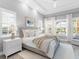 Bright main bedroom featuring natural lighting, neutral colors, and a ceiling fan at 16407 Daysailor Trl, Lakewood Ranch, FL 34202