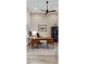 Home office featuring a wooden desk, ceiling fan, and natural light from a window at 16407 Daysailor Trl, Lakewood Ranch, FL 34202