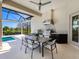 Outdoor kitchen with stainless steel grill and dining area for outdoor living at 16407 Daysailor Trl, Lakewood Ranch, FL 34202