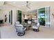 Inviting covered patio with comfortable seating and a view of the open kitchen and outdoor pool area at 16407 Daysailor Trl, Lakewood Ranch, FL 34202