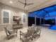 Covered patio with neutral furniture, ceiling fan, and a view of the in-ground pool and spa at 16407 Daysailor Trl, Lakewood Ranch, FL 34202