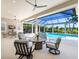 Relaxing screened-in patio features comfortable seating and a view of the sparkling pool and lush backyard at 16407 Daysailor Trl, Lakewood Ranch, FL 34202