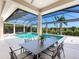 Stunning screened in pool with adjacent spa and surrounding landscaping for serene relaxation at 16407 Daysailor Trl, Lakewood Ranch, FL 34202