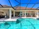 Large pool and spa area with a screened-in pool and an outdoor kitchen at 16407 Daysailor Trl, Lakewood Ranch, FL 34202