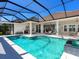 A large, screened-in pool with an attached spa and an outdoor kitchen area at 16407 Daysailor Trl, Lakewood Ranch, FL 34202