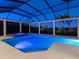 Beautiful in-ground pool and hot tub with screened enclosure for year-round enjoyment, set against lush landscaping at 16407 Daysailor Trl, Lakewood Ranch, FL 34202