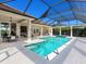 A screened-in pool and jacuzzi with a brick patio surround and a covered patio space at 16407 Daysailor Trl, Lakewood Ranch, FL 34202