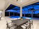 Night view of a screened-in pool with a jacuzzi and outdoor seating under a covered patio at 16407 Daysailor Trl, Lakewood Ranch, FL 34202