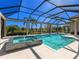 Inviting screened in pool and spa with view of the landscaped backyard oasis at 16407 Daysailor Trl, Lakewood Ranch, FL 34202