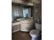 Bathroom with patterned wallpaper, hexagon tile floor and corner vanity with sink at 1862 Orangewood Ln, Sarasota, FL 34232