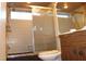 Bathroom with low shower head and dated brown-colored trim at 1862 Orangewood Ln, Sarasota, FL 34232