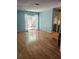 Bedroom with light blue walls, wood floors, and a sliding glass door to an enclosed backyard at 1862 Orangewood Ln, Sarasota, FL 34232