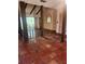 Spacious living room featuring a vaulted ceiling, exposed beams, and tile flooring at 1862 Orangewood Ln, Sarasota, FL 34232