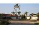 Suburban street view with palm trees, green lawns, and single Gathering homes at 1862 Orangewood Ln, Sarasota, FL 34232