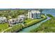 Beautiful aerial view of condos alongside the river with verdant lawns and scenic waterfront at 2010 Harbourside Dr # 2004, Longboat Key, FL 34228