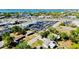 Aerial view of a commercial real estate property with parking and surrounding trees near a waterfront with clear blue skies at 2039 Kai Dr, Sarasota, FL 34231