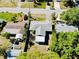 Aerial view of a single-story home with a gray roof and compact yard on a sunny day in a quiet neighborhood at 2039 Kai Dr, Sarasota, FL 34231