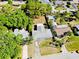 An aerial view showcases the home's location within a neighborhood, highlighting its driveway and nearby mature trees at 2039 Kai Dr, Sarasota, FL 34231