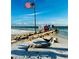 Scenic beach with American flag and waterfront view, perfect for relaxation and recreation at 2039 Kai Dr, Sarasota, FL 34231
