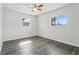 Bright bedroom with neutral walls, wood-look floors, and two windows offering ample natural light at 2039 Kai Dr, Sarasota, FL 34231