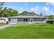 Charming single-story home with a well-manicured lawn and a classic front door at 2039 Kai Dr, Sarasota, FL 34231
