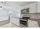 Well-appointed kitchen with stainless steel appliances and modern backsplash at 2039 Kai Dr, Sarasota, FL 34231
