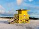 A yellow lifeguard stand sits on a white sand beach at 2039 Kai Dr, Sarasota, FL 34231