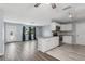 Open-concept living space with modern gray wood flooring and bright kitchen at 2039 Kai Dr, Sarasota, FL 34231