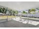 A screened patio with concrete flooring offers an indoor-outdoor experience with a view of the fenced backyard at 2039 Kai Dr, Sarasota, FL 34231