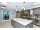 Modern kitchen with an island and stainless steel appliances at 2045 Gulf Of Mexico Dr # M1-310, Longboat Key, FL 34228