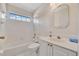 Bright bathroom features a tub, shower, and vanity with white cabinets at 2407 Waterford Ct, Palmetto, FL 34221