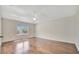 A spacious bedroom features hardwood floors, a ceiling fan, and a window at 2407 Waterford Ct, Palmetto, FL 34221
