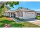 Charming single-story home with a well-maintained lawn and a two-car garage at 2407 Waterford Ct, Palmetto, FL 34221