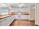 Bright kitchen features white appliances, white cabinetry and hardwood flooring at 2407 Waterford Ct, Palmetto, FL 34221